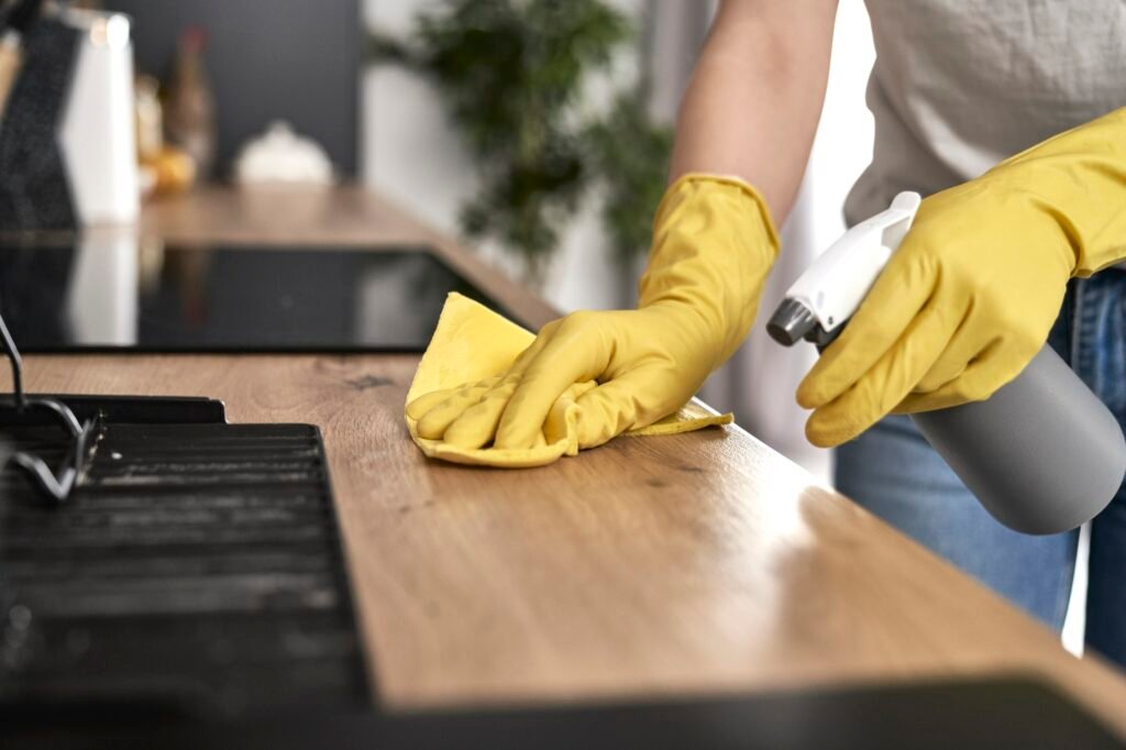 close up of caucasian woman cleaning kitchen at home