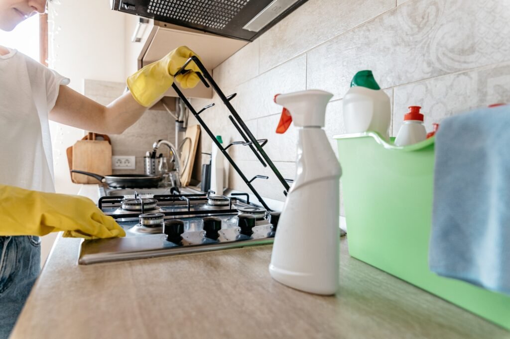 woman cleaning the kitchen of her apartment